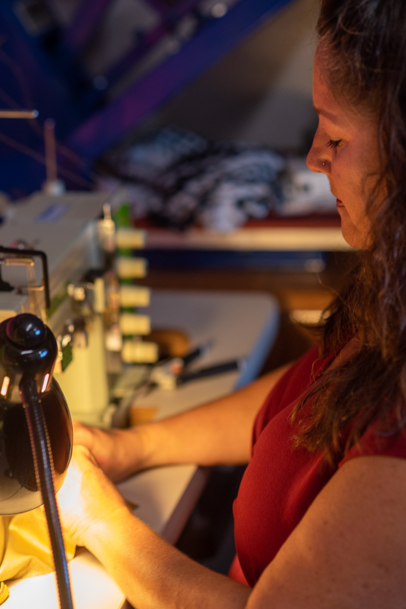 Sew Skimpy founder sewing an original garment design at a sewing machine